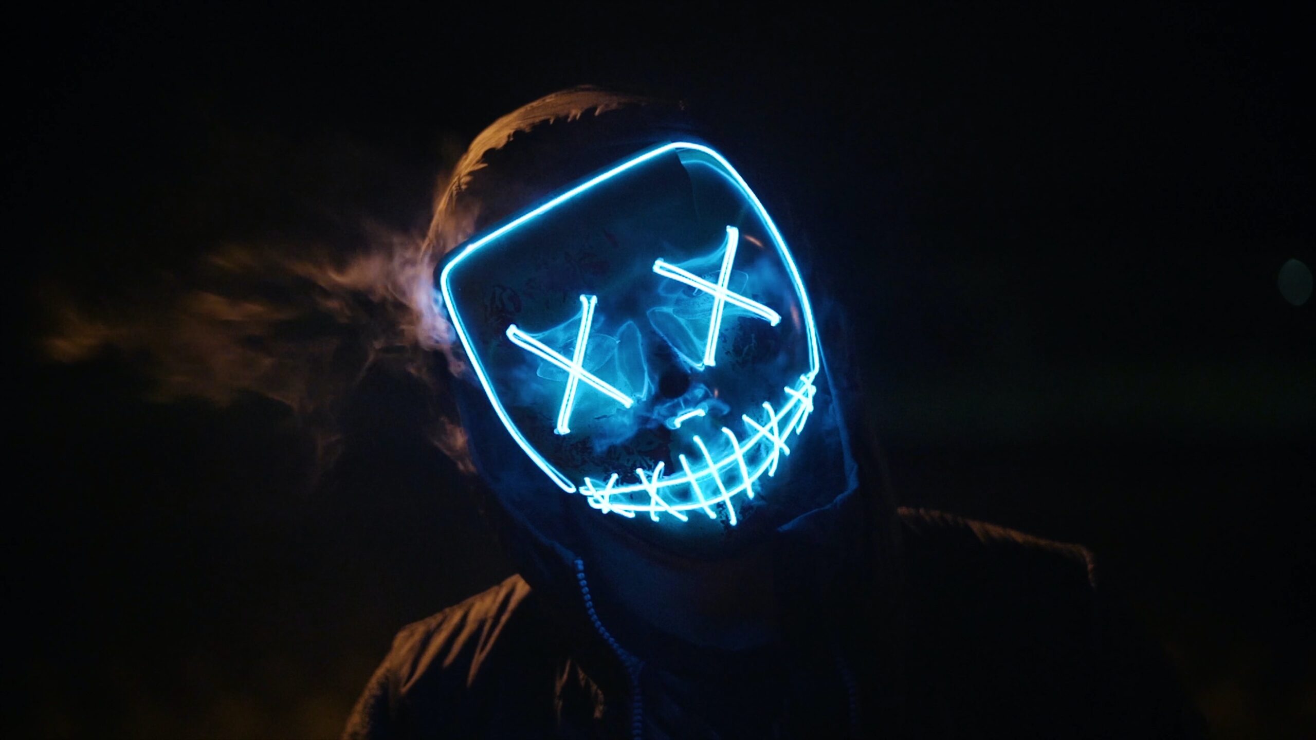 Person wearing hacker mask